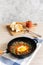 Shakshuka Israeli breakfast: stewed vegetables, scrambled eggs, tomato juice and slices of homemade bread