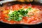 Shakshuka. Traditional jewish food and middle eastern cuisine recipe. Fried eggs, tomatoes, bell pepper and parsley in a