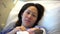 Shaky handheld footage of Asian Chinese mother lying on hospital bed and carrying her newborn