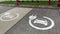 Shaky handheld: Many electric vehicle charging lot signs on pavement at parking lot