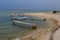 Shaky wooden molos and fisherman boats on beach in Croatia during cloudy day before the rain