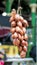 Shallots onions hanging to dry at food market