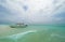 Shallow atoll sandbanks turquoise waves with lonely pleasure boat around Mnemba island in the Indian Ocean near the Zanzibar