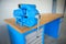 Shallow depth of field image with a heavy iron vice on a workbench inside a workshop with no people around