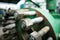 Shallow depth of field image with worn out heavy iron industrial equipment used in the oil and gas drilling industry rusty bolts