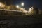 A shallow depth of field, low angle shot of street lights and traffic trails at night