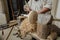 Shallow depth of field selective focus details with a craftsman using an ancient Roman woodturning lathe to make a bowl during a