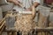 Shallow depth of field selective focus details with a craftsman using an ancient Roman woodturning lathe to make a bowl during a