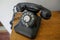 Shallow depth of field selective focus details with an old and dusty dial rotary phone from the communist Romania era