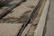 Shallow depth of field selective focus details with old, rusty and worn out tram rails on the streets of Bucharest