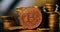 Shallow depth of field selective focus image with a Bitcoin metal coin near other metal coins - cryptocurrency concept