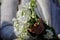 Shallow depth of field selective focus image with the hands of a woman holding a bouquet of freesias on a sunny spring day
