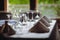 Shallow depth of field selective focus image with a restaurant table ready to receive customers. Empty glasses and tableware