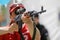 Shallow depth of field selective focus image with a Romanian paramedic aiming a Dragunov sniper rifle during an exhibition