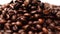 Shallow depth of field shot of Dark Coffee beans,Coffee beans splashed from above