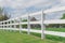 Shallow DOF long white fence with defocused farm house ranch in background in Ennis, Texas, USA