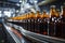 Shallow DOF reveals meticulous beer bottle arrangement on conveyor, emphasizing manufacturing excellence