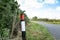 Shallow focus of a bent over, plastic traffic bollard .