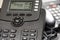 Shallow focus image of a generic VOIP business telephone showing part of its keypad and LCD display.