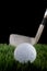 Shallow focus image of a golf ball and club