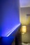 Shallow focus of modern LED ambient mood lighting seen in a modern apartment bedroom.