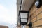 Shallow focus of a newly installed, multi colour smart lighting lantern outside the rear door of a house.