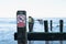 Shallow focus of a No Swimming sign attached to a wooden groyne at a beach.