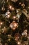 Shallow focus shot of beautiful baubles and string lights hanging on a Christmas tree