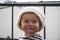 Shallow focus shot of a cute little baby in a white knitted winter hat