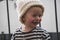 Shallow focus shot of a cute little smiling baby in a white knitted winter hat