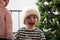 Shallow focus shot of a cute little smiling baby in a white knitted winter hat