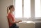 Shallow focus shot of a young female working with her laptop on bright room background