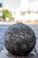 Shallow focus vertical shot of a cement ball