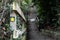 Shallow focus of a yellow footpath direction sign seen attached to a wooden bannister