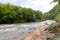 Shallow riverbed with a rocky bottom , unhurried flow of water