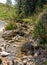 Shallow riverbed with a rocky bottom , unhurried flow of water, autumn walks in nature