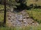 Shallow riverbed with a rocky bottom , unhurried flow of water, autumn walks in nature