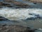 Shallow stone rapids of a mountain river