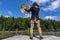 Shaman man on dock with sacred drum and stick