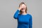 So shameful, i`d rather not watch this! Portrait of bashful positive woman covering eyes with hand. isolated on gray background