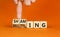 Shaming and belittling symbol. Concept words Shaming and Belittling on wooden cubes. Businessman hand. Beautiful orange table
