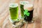 Shamrock on glass of beer and horseshoe on table