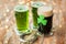 Shamrock on glass of beer and horseshoe on table