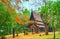 The Shan Pavilion, shady garden and blloming flame tree in Baan Dam Black house complex, on May 11 in Chiang Rai, Thailand