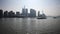 Shanghai bund viewed from ferry ship, skyscrapers and landmarks with blue sky background, cargo ships sailing on Huangpu river