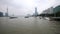 Shanghai, China - Feb. 21, 2019: cargo ships sailing in Huangpu river with Shanghai Bund skyscraper landscape and overcast sky