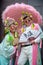 Shanghai, China - November 2019: Young couple dressed in colourful Chinese costume posing for pre-wedding photos
