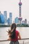 Shanghai city ferry boat on Bund river cruise ship travel woman tourist sightseeing Oriental Pearl tv tower landmark