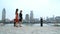 Shanghai women walking in Pudong by huangpu river with view of the Bund