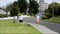 Shannon, Ireland - Sept 5, 2015: Couple walking their dog and following the law by cleaning up after their dog poop with a poop sc